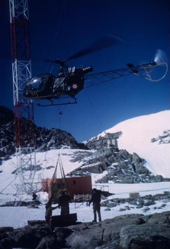 L'hélicoptère Alouette 2 en opération de transport au pied du pylône du sondeur ionosphérique.