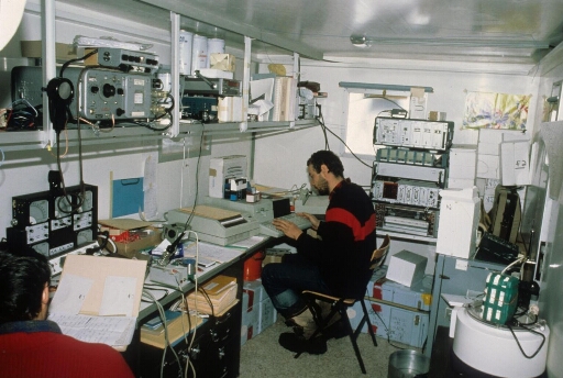 A D57, programme IAGO : l'intérieur du shelter radio, deux opérateurs, transmission télex en cours.