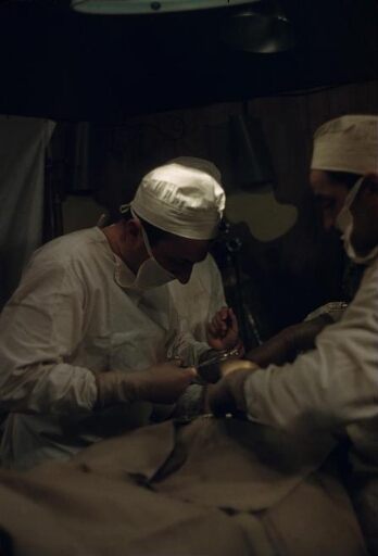 Intervention chirurgicale : dans une salle d'opération improvisée, le médecin Gilbert Goy (à gauche) opère André Lebeau. A ses côtés l'un des ses trois assistants.