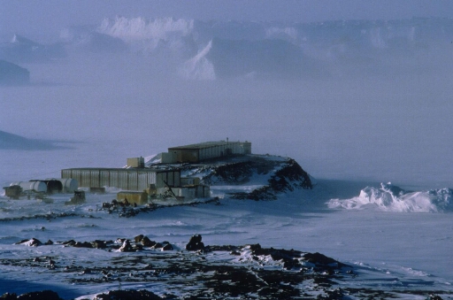 La base vie du chantier de la piste du Lion sous la neige au cours de l'hiver 1988. Les icebergs en arrière-plan sont voilés par le chasse-neige.